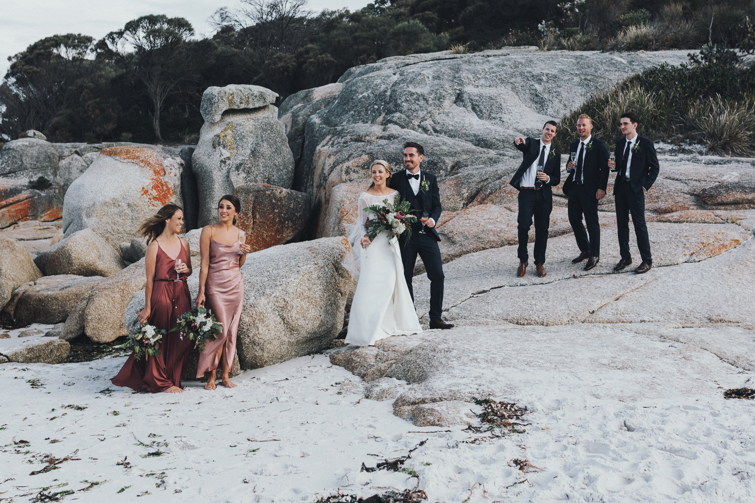 Bridal party relax in classic beach wedding with style in Tasman