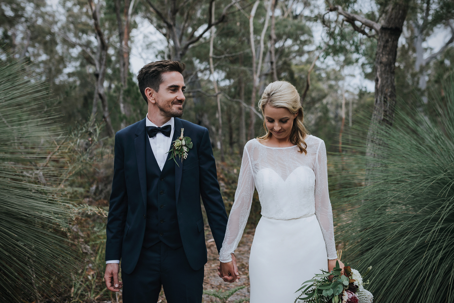 Groom smiles at his bride at Bay of Fires bush retreat wedding.