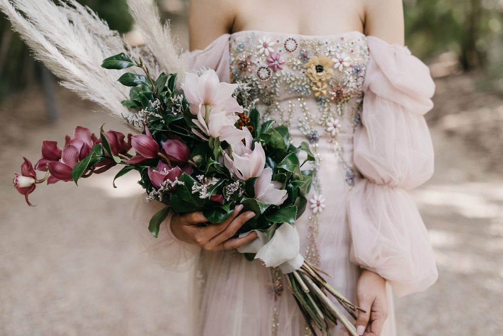 Close up of wedding dress and flower bouquet