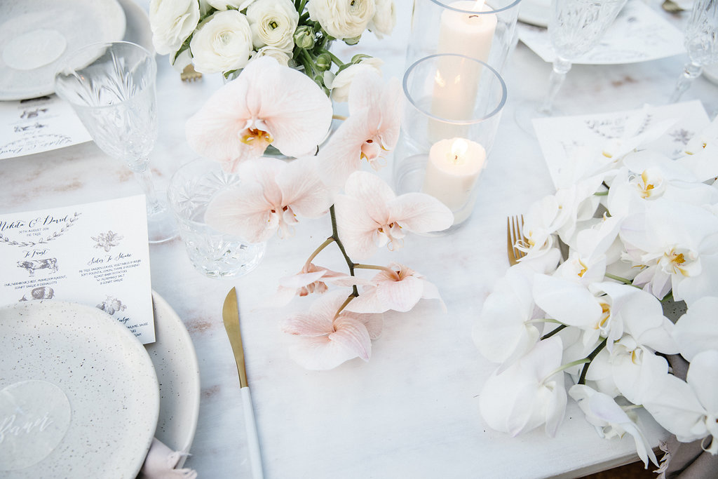 Reception table set up with soft flowers / Wedding photography