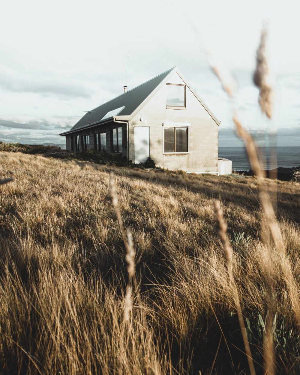 Tasmania Hilltop view of building in countryside and beach / Elopement photography