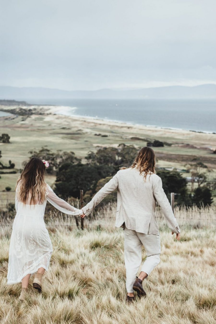 Bride and Groom walking through Tasmania Hilltop / Elopement photography