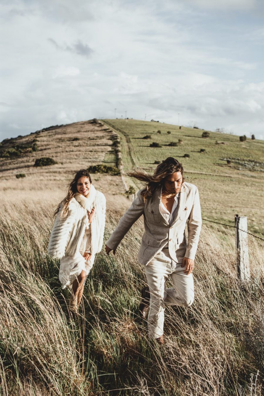 Groom leading bride through Tasmania Hilltop / Elopement photography