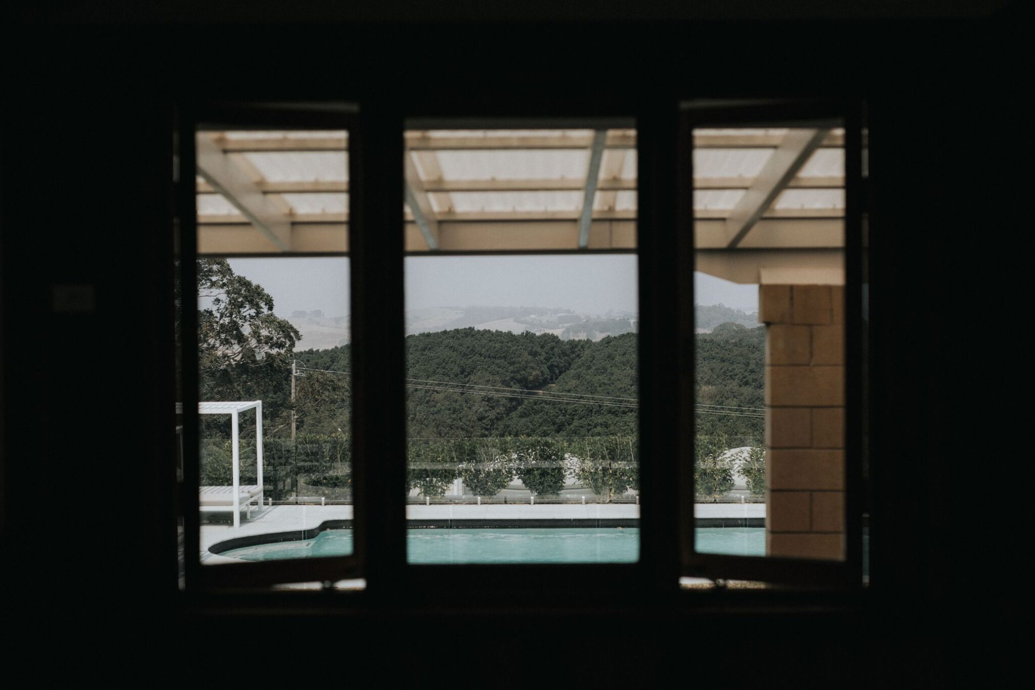 View out to pool and hillside of trees.